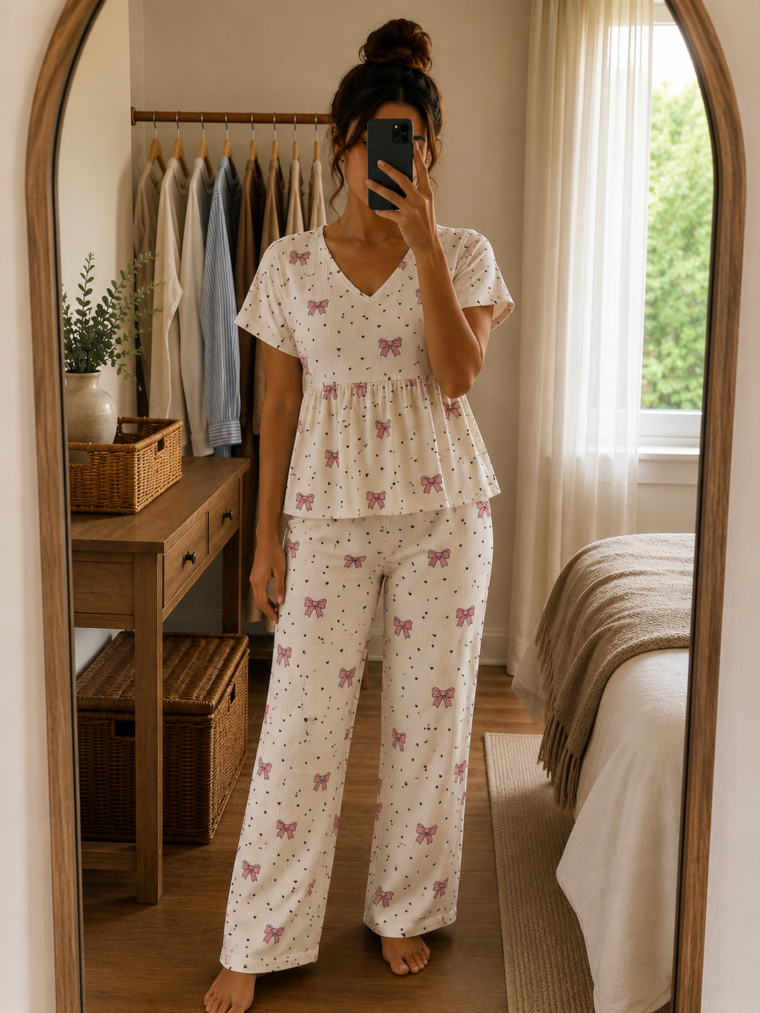 Woman wearing a premium ribbed cotton peplum night suit with pink bow print, V-neck top, and matching straight-fit lounge pants by Irah Vastra.