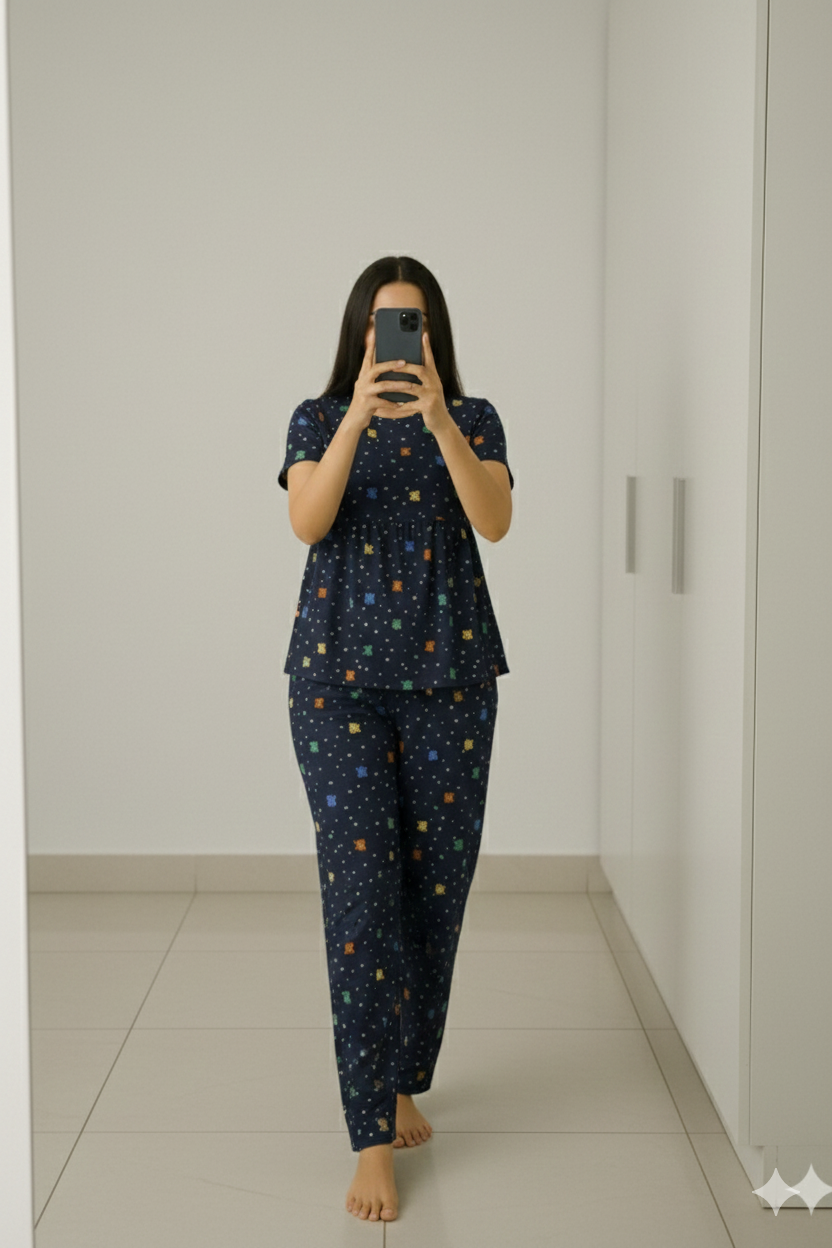 Woman wearing navy blue peplum nightwear set at home