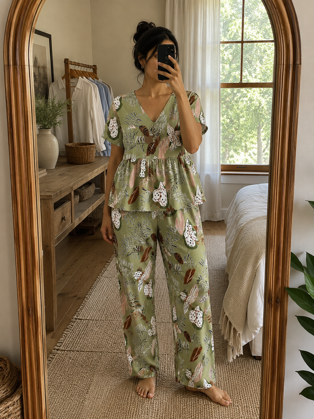 Woman wearing a premium sage green botanical print cotton peplum night suit with a V-neck top and matching straight-fit lounge pants by Irah Vastra.