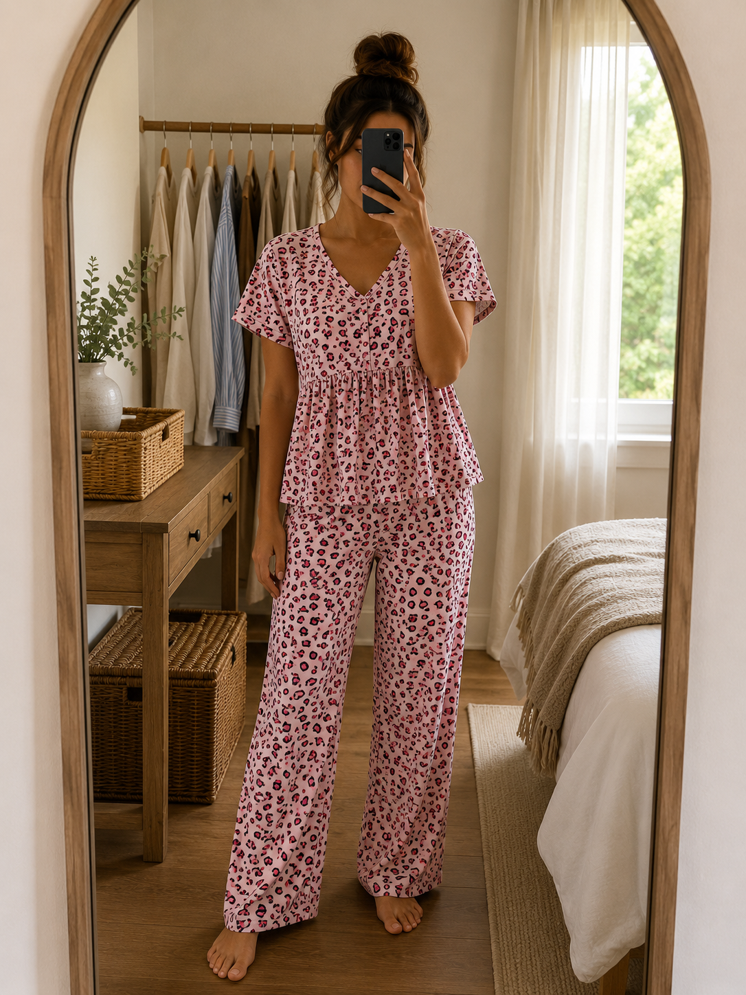 Woman wearing a premium ribbed knitted cotton pink leopard print peplum night suit with a V-neck top and matching straight-fit lounge pants by Irah Vastra.